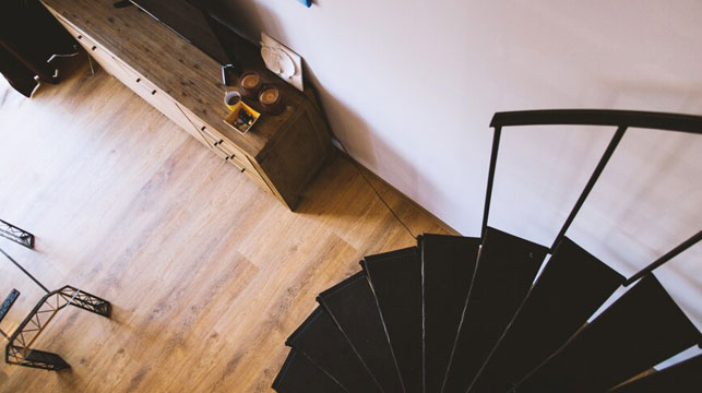 overhead-shot-black-spiral-stairs-near-drawer-with-tv-top_181624-3716